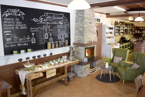 a restaurant with a fireplace and a table and chairs at Guest House Pod Grebenom in Podčetrtek