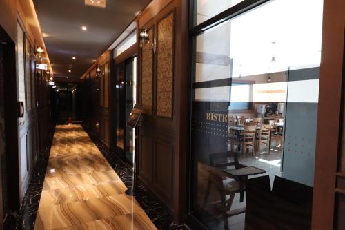 a corridor of a restaurant with a table and chairs at Hotel Airport in Busan