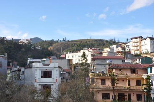 a group of buildings in a city with a hill at Hotel Sao Xanh in Sa Pa