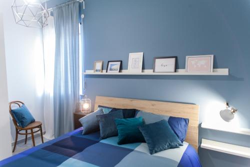 ein blaues Schlafzimmer mit einem Bett mit blauen Kissen in der Unterkunft Casa Vacanze Eco del Mare in Agrigento