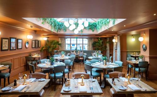 a restaurant with tables and chairs in a room at Hotel Du Vin & Bistro York in York