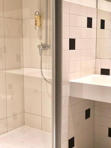 a bathroom with a shower and a sink at Hotel Arena Inn - Berlin Mitte in Berlin
