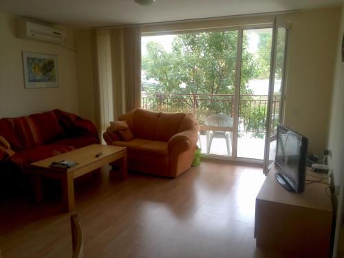 - un salon avec un canapé, une table et une télévision dans l'établissement Magical apartment in Marina view Fort beach, à Sveti Vlas
