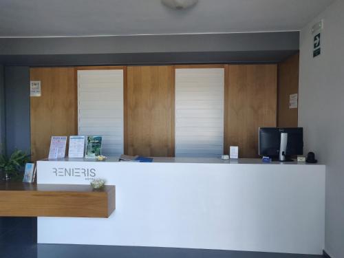 a reception area of a hospital with a white counter at Renieris Hotel in Stalos