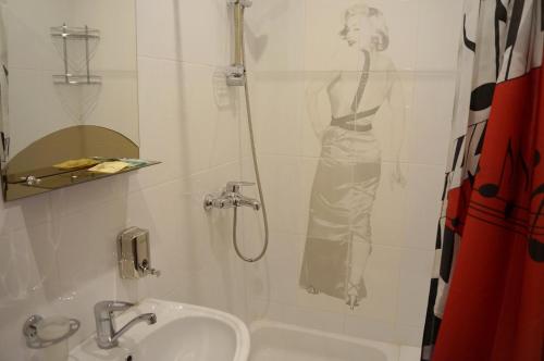 a bathroom with a shower with a woman on the wall at Hotel in Kolomna in Kolomna