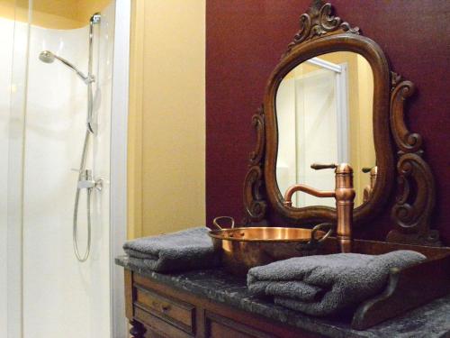 a bathroom with a sink and a mirror at Holiday Home in Bièvre with Terrace in Bièvre