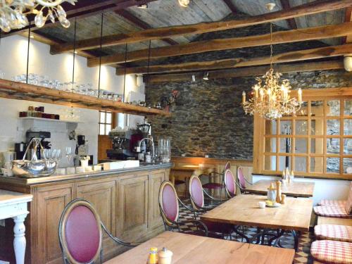 a kitchen with wooden tables and chairs in a room at Holiday Home in Bièvre with Terrace in Bièvre