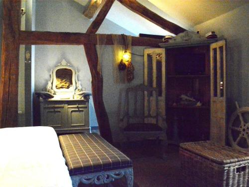 a bedroom with a bed and a table and a chair at Holiday Home in Bièvre with Terrace in Bièvre