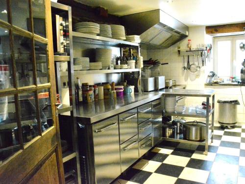 a large kitchen with a checkered floor at Holiday Home in Bièvre with Terrace in Bièvre
