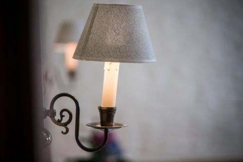 a lamp with a candle on top of it at Hotel - Restaurant Soleo in Krumpendorf am Wörthersee