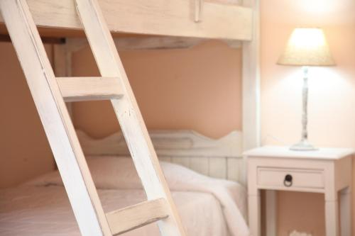a ladder to a bunk bed in a room at Ventoura Studios & Apartments in Galissas