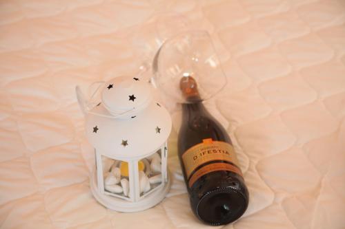 a bottle of wine sitting next to a glass trophy at Ventoura Studios & Apartments in Galissas