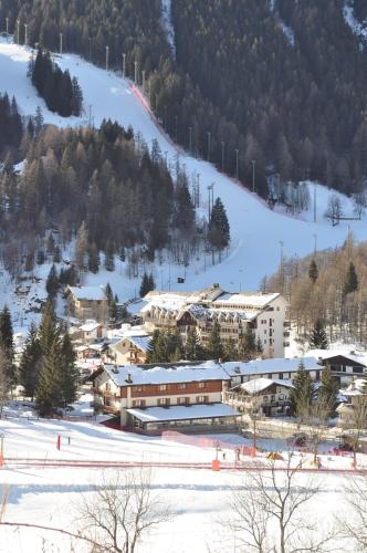 a ski resort in the snow next to a ski slope at Hotel Flora Alpina in Gressoney-Saint-Jean