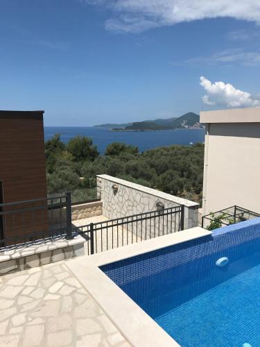 a swimming pool on the side of a house at Adria Lux Apartments Sveti Stefan in Budva