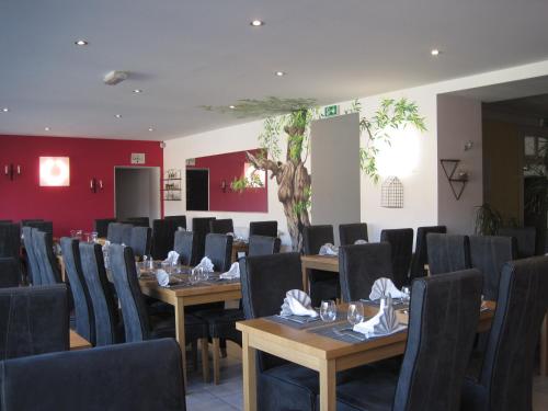 a conference room with wooden tables and chairs at Hotel Des Négociants in Lamastre