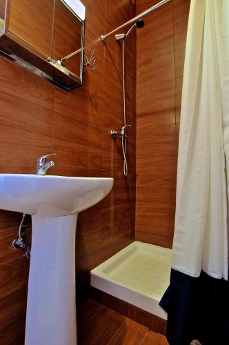 a bathroom with a sink and a shower at Norte Guest House in Lisbon