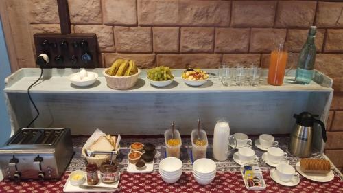 a table with cups and bowls of food on a counter at Baijoo Niwas in Jodhpur