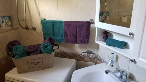 a bathroom with a box of towels on top of a sink at City Park Apartments in Pristina