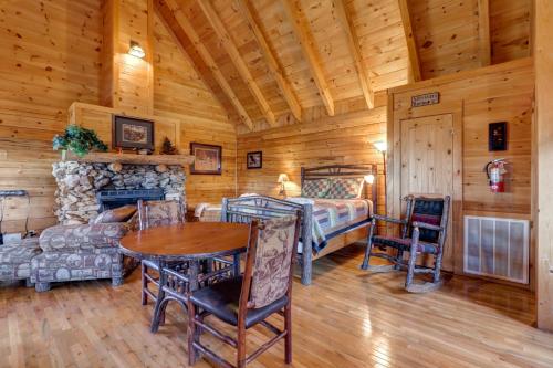 a living room with a table and a bed and a fireplace at Majestic View #42B in Sevierville