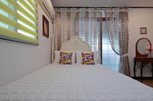 a bedroom with a large white bed with two pillows at Yejeon Pension in Gyeongju