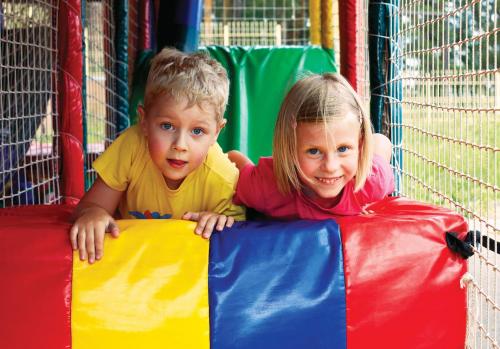 a young boy and a girl playing in a play structure at Macdonald Woodland Lodges at Macdonald Aviemore Resort in Aviemore