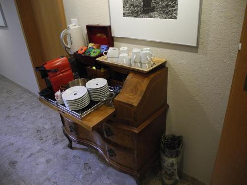 a table with plates and cups on top of it at Landgasthaus Bären in Grub