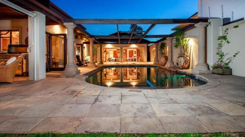 a swimming pool in the middle of a house at Manor 38 in Port Elizabeth