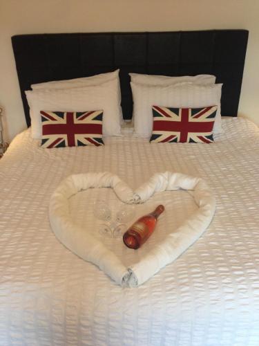 a heart made out of a bottle on a bed at Langland Road B&B in The Mumbles