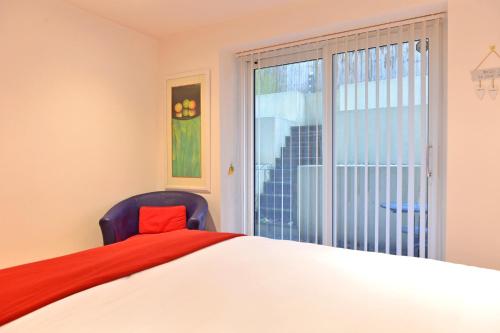 a bedroom with a large bed and a window at The Sanctuary in Eastbourne