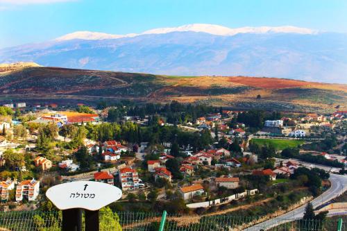 an aerial view of a town with mountains in the background at Metulla Travel Hotel in Metulla