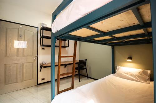 a bedroom with a bunk bed and a desk at Kaelyn Cozy Living in Bangkok