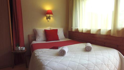 a hotel room with a bed with towels on it at VVF Les Gorges de l'Allier in Lavoûte-Chilhac