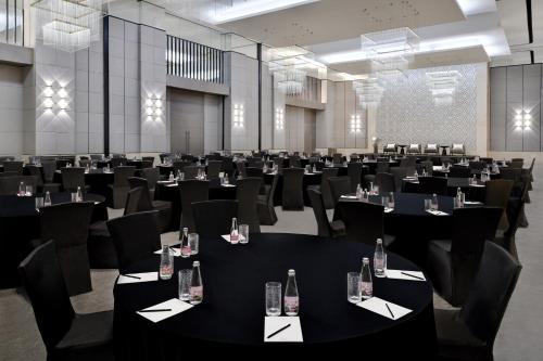 a conference room with black tables and chairs at Kempinski Central Avenue Dubai in Dubai