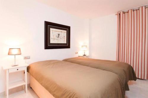 a hotel room with a bed and a window at Apartment near the Pine Walk in Pollença