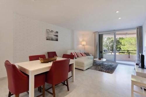 a living room with a table and chairs and a couch at Apartment near the Pine Walk in Pollença