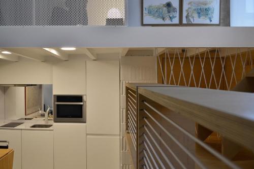 a kitchen with white cabinets and a counter top at ATERIAN LOFT 2 in Zarautz
