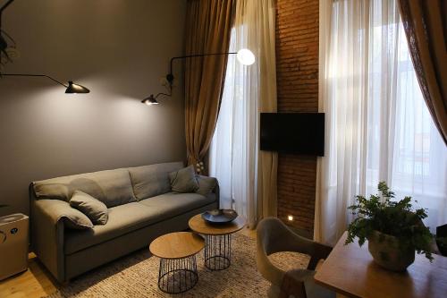 a living room with a couch and a table at Paskunji Residence in Tbilisi City