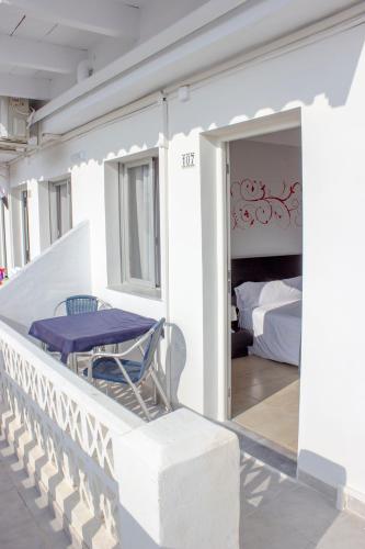 a balcony with a table and a bed in a room at Hostal Alba in La Mata
