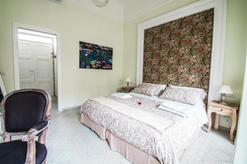 a bedroom with a large bed and a chair at Domus Sibyllina, Galleria Umberto I in Naples