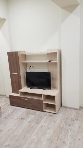 a entertainment center with a television in a room at Guest rooms Super center PLOVDIV perfect location in Plovdiv