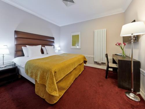 a hotel room with a large bed and a desk at La Boutique in Prague