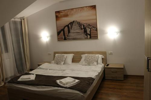 En eller flere senge i et værelse på Timisoara City Apartments