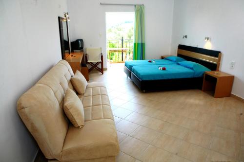 a living room with a couch and a bed at Villa Thomas Valtos beach in Parga