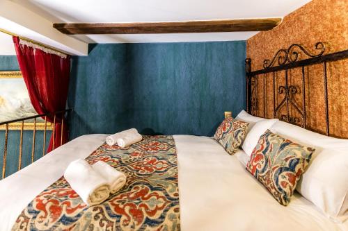 a bedroom with a bed with towels on it at Tiflis Inn Boutique Hotel in Tbilisi City