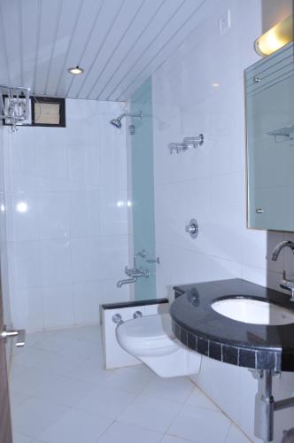 a bathroom with a toilet and a sink and a shower at Hotel Crystal inn Nakki Lake 25 Meter in Mount Ābu