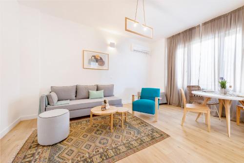 a living room with a couch and a table at Maryflower Premium Apartments Piraeus in Piraeus