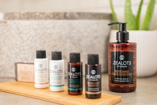 a group of four products sitting on a wooden shelf at Maryflower Premium Apartments Piraeus in Piraeus