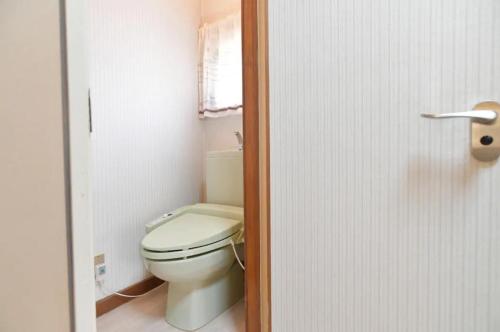 a bathroom with a white toilet and a window at STAY IN OTAKI in Date