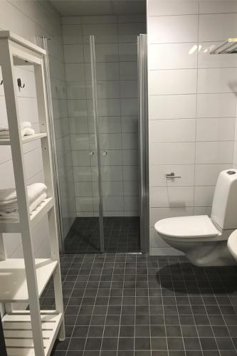 a bathroom with a shower and a toilet and a sink at Rasta Värnamo in Värnamo