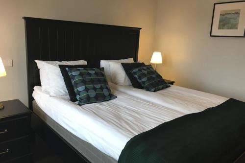 a bedroom with a large bed with two pillows at Rasta Värnamo in Värnamo